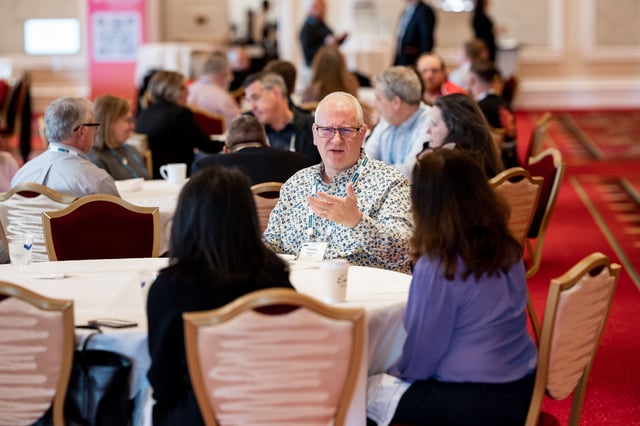 An attendee leading a discussion at a round table
