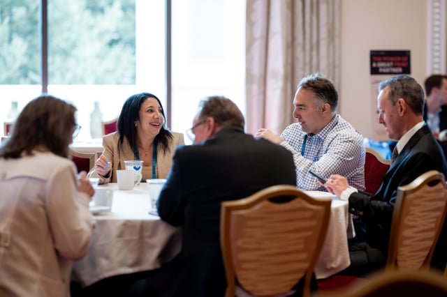 A small group in conversation at a roundtable